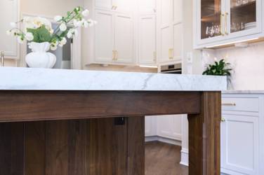 Two-tone white kitchen with walnut Buckskin-stained island and marble counters in Raleigh, NC
