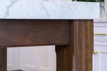 Two-tone white kitchen with walnut Buckskin-stained island and marble counters in Raleigh, NC