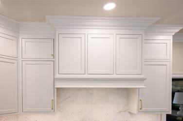 Two-tone white kitchen with walnut Buckskin-stained island and marble counters in Raleigh, NC