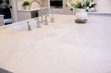 Two-tone white kitchen with walnut Buckskin-stained island and marble counters in Raleigh, NC