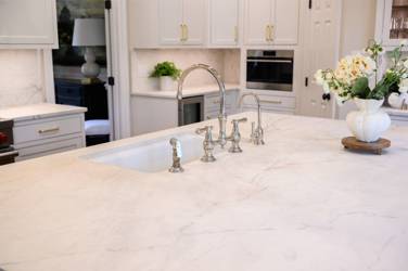 Two-tone white kitchen with walnut Buckskin-stained island and marble counters in Raleigh, NC