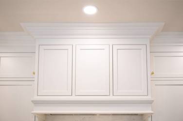Two-tone white kitchen with walnut Buckskin-stained island and marble counters in Raleigh, NC