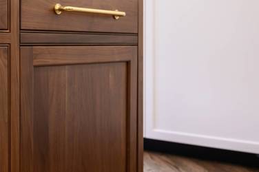 Two-tone white kitchen with walnut Buckskin-stained island and marble counters in Raleigh, NC