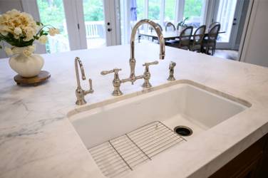 Two-tone white kitchen with walnut Buckskin-stained island and marble counters in Raleigh, NC