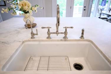Two-tone white kitchen with walnut Buckskin-stained island and marble counters in Raleigh, NC