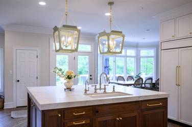 Two-tone white kitchen with walnut Buckskin-stained island and marble counters in Raleigh, NC
