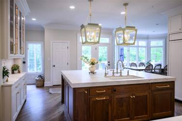 Two-tone white kitchen with walnut Buckskin-stained island and marble counters in Raleigh, NC