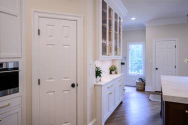 Two-tone white kitchen with walnut Buckskin-stained island and marble counters in Raleigh, NC