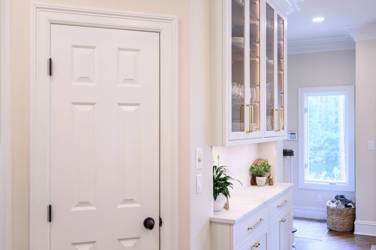 Two-tone white kitchen with walnut Buckskin-stained island and marble counters in Raleigh, NC