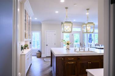 Two-tone white kitchen with walnut Buckskin-stained island and marble counters in Raleigh, NC
