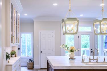 Two-tone white kitchen with walnut Buckskin-stained island and marble counters in Raleigh, NC