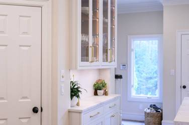 Two-tone white kitchen with walnut Buckskin-stained island and marble counters in Raleigh, NC