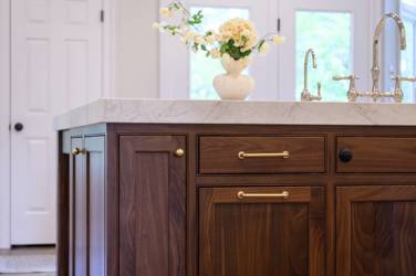 Two-tone white kitchen with walnut Buckskin-stained island and marble counters in Raleigh, NC