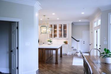 Two-tone white kitchen with walnut Buckskin-stained island and marble counters in Raleigh, NC