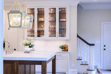 Two-tone white kitchen with walnut Buckskin-stained island and marble counters in Raleigh, NC