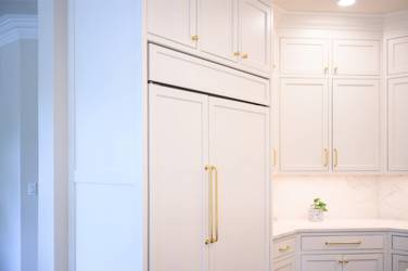 Two-tone white kitchen with walnut Buckskin-stained island and marble counters in Raleigh, NC