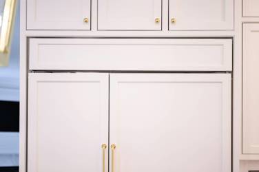 Two-tone white kitchen with walnut Buckskin-stained island and marble counters in Raleigh, NC