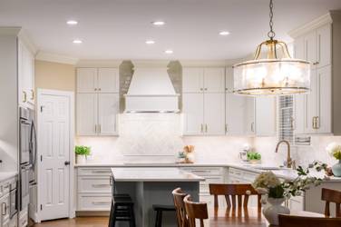White kitchen with gray island and herringbone tile backsplash in Cary, NC