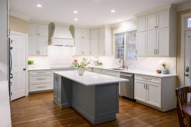 White kitchen with gray island and herringbone tile backsplash in Cary, NC