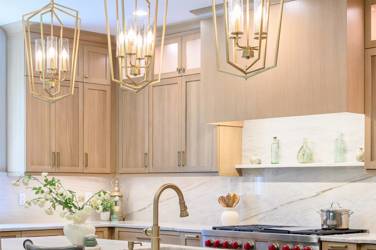 White oak kitchen with sage green island and white quartzite waterfall counters in Raleigh, NC