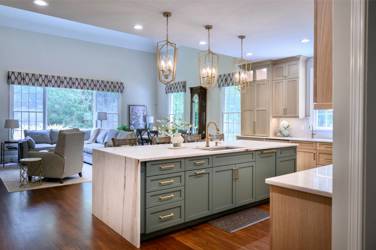 White oak kitchen with sage green island and white quartzite waterfall counters in Raleigh, NC