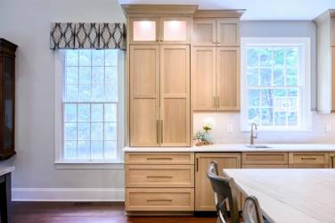 White oak kitchen with sage green island and white quartzite waterfall counters in Raleigh, NC